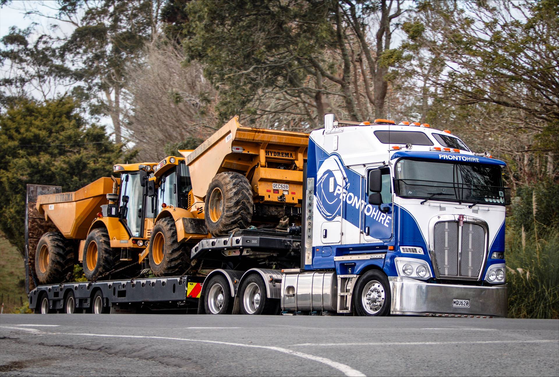 Two Hydrema 912 12 Ton Articulated Dumper for hire from Pronto Hire Auckland on transport truck